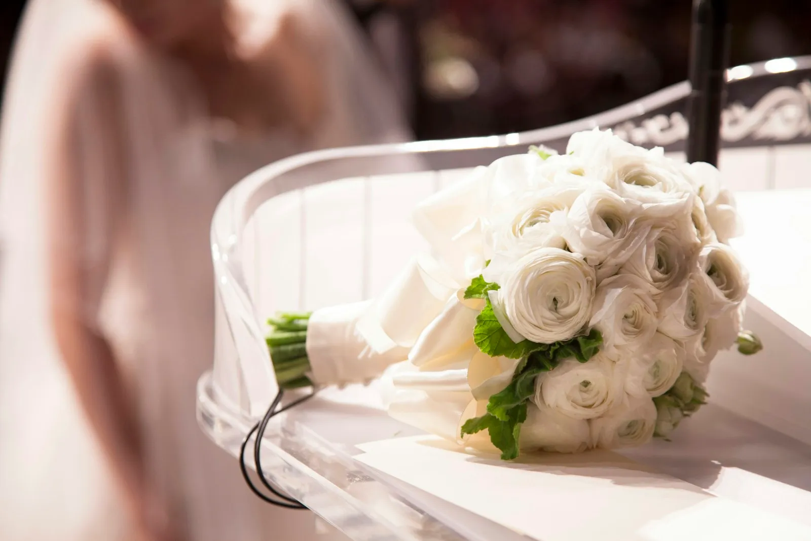 A wedding bouquet with soft-coloured flowers and greenery