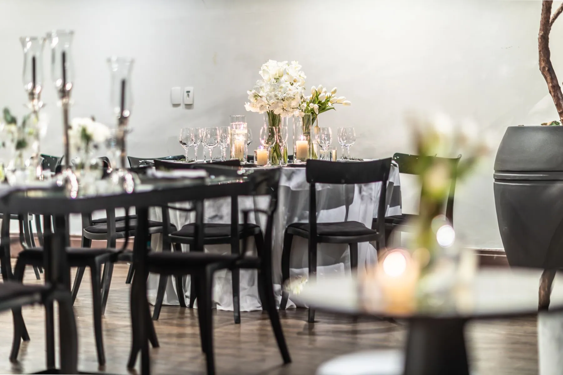 An indoor reception setting with flowers and candlelight